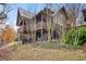 Charming log cabin exterior with a multi-level deck, natural landscaping, and serene outdoor space at 49 Holly Springs Ne Rd, White, GA 30184
