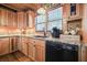 Functional kitchen with black appliances, stone backsplash, and wooden cabinets at 49 Holly Springs Ne Rd, White, GA 30184
