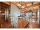 Stylish kitchen island with stone accents, wooden cabinets and stainless steel appliances at 49 Holly Springs Ne Rd, White, GA 30184