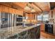 Modern kitchen with stainless steel appliances, wooden cabinets, and stone countertop at 49 Holly Springs Ne Rd, White, GA 30184