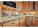 Charming kitchen featuring wooden cabinets, granite countertops, and under-cabinet lighting at 49 Holly Springs Ne Rd, White, GA 30184