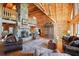 Inviting living area with a stone fireplace, hardwood floors, and exposed wooden beams at 49 Holly Springs Ne Rd, White, GA 30184