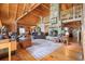 Open-concept living room featuring wood finishes, stone fireplace, and a clear view of the dining area at 49 Holly Springs Ne Rd, White, GA 30184