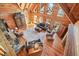 Spacious living room featuring wood floors, stone fireplace, and vaulted ceilings with many windows for natural light at 49 Holly Springs Ne Rd, White, GA 30184