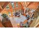 Vaulted ceiling living room with hardwood floors, wood walls, a stone fireplace and large windows at 49 Holly Springs Ne Rd, White, GA 30184
