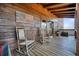 Relaxing covered porch with rocking chairs, an American flag, and a wooden plank floor at 49 Holly Springs Ne Rd, White, GA 30184