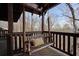 Relaxing wooden porch swing offers a peaceful retreat to enjoy the scenic views at 49 Holly Springs Ne Rd, White, GA 30184