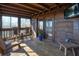 Enjoy views from screened porch with wooden rocking chairs, bench, and entertainment at 49 Holly Springs Ne Rd, White, GA 30184