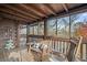 Enjoy wooded views from the screened porch with wooden seating and rustic charm at 49 Holly Springs Ne Rd, White, GA 30184