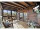Screened porch provides a relaxing outdoor living space with wooden rocking chairs and peaceful views at 49 Holly Springs Ne Rd, White, GA 30184
