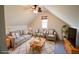 Attic living room featuring a cozy sitting area with neutral colors and great natural light at 2725 Monet Dr, Cumming, GA 30041