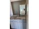 Bathroom with granite countertops, white cabinets, and modern fixtures at 504 Overlook Rd, Covington, GA 30052