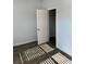 Bright bedroom with wood-look floors, white door, and closet space at 504 Overlook Rd, Covington, GA 30052