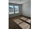 Bedroom with two windows that let in natural light and neutral color carpet at 504 Overlook Rd, Covington, GA 30052