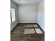 Bright bedroom featuring wood-look floors, and a light-filled window at 504 Overlook Rd, Covington, GA 30052