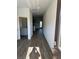 Inviting hallway leads to kitchen with granite counters, and outdoor view at 504 Overlook Rd, Covington, GA 30052