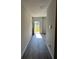 Hallway with an open door leading to a sunny view of the outdoors at 504 Overlook Rd, Covington, GA 30052