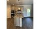 Open kitchen featuring stainless appliances, granite countertops, and modern lighting at 504 Overlook Rd, Covington, GA 30052