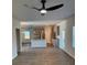 Open-concept living room with modern ceiling fan, gray cabinets, and hardwood floors at 504 Overlook Rd, Covington, GA 30052