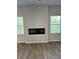 Living room with fireplace between two windows providing natural light at 504 Overlook Rd, Covington, GA 30052