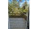 Outdoor patio with a wood railing overlooking nature at 504 Overlook Rd, Covington, GA 30052