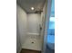 A pristine white tiled shower features a modern rain shower head and built-in bench seating at 504 Overlook Rd, Covington, GA 30052
