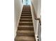 Carpeted staircase features an oak railing with black iron spindles at 504 Overlook Rd, Covington, GA 30052