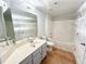 Neutral bathroom featuring an oversized mirror, white countertop and honey colored floor at 245 Amal Sw Dr # 1008, Atlanta, GA 30315