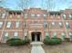 Three-story brick apartment building featuring well-maintained landscaping at 245 Amal Sw Dr # 1008, Atlanta, GA 30315