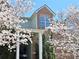 Exterior view of brick condo building with lush landscaping and blossoming trees at 245 Amal Sw Dr # 1008, Atlanta, GA 30315