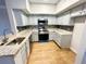 Modern kitchen features stainless steel appliances, granite countertops, and wood flooring at 245 Amal Sw Dr # 1008, Atlanta, GA 30315