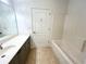 Bathroom features a large vanity, shower-tub, and tile flooring at 1873 Jameson Cir, Lawrenceville, GA 30043
