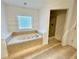 Bathroom featuring a soaking tub and separate shower at 1873 Jameson Cir, Lawrenceville, GA 30043