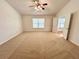 Spacious bedroom with carpet flooring, a ceiling fan, and an abundance of natural light at 1873 Jameson Cir, Lawrenceville, GA 30043