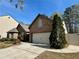 Brick home featuring a two-car garage and well-manicured landscaping at 1873 Jameson Cir, Lawrenceville, GA 30043