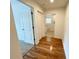 Hallway featuring hardwood floors leading to the laundry room and bedroom at 1873 Jameson Cir, Lawrenceville, GA 30043