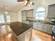 Kitchen featuring stainless steel appliances, gray cabinets, and a granite island at 1873 Jameson Cir, Lawrenceville, GA 30043