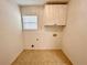 Functional laundry room featuring tile flooring and built-in cabinets for storage convenience at 1873 Jameson Cir, Lawrenceville, GA 30043