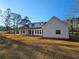 Striking two story home with white siding, lots of windows, and a covered patio at 1632 Oleander Sw Dr, Lilburn, GA 30047