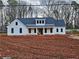 Charming new construction farmhouse with white board and batten siding and a dark roof at 1632 Oleander Sw Dr, Lilburn, GA 30047