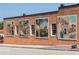 Brick wall with vibrant murals depicting scenes of local life and history at 653 Georgetown Ln, Jonesboro, GA 30236