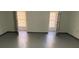 Spacious basement with concrete floors, neutral walls, and abundant natural light through two windows at 229 Smithstone Path, Fayetteville, GA 30214