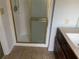 Bathroom featuring a shower with gold frame, vanity and tiled floor at 229 Smithstone Path, Fayetteville, GA 30214