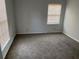 Carpeted bedroom featuring neutral walls and natural light from two windows at 229 Smithstone Path, Fayetteville, GA 30214