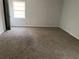 Neutral bedroom showcasing carpet, window with blinds, and a white door at 229 Smithstone Path, Fayetteville, GA 30214