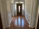 Inviting foyer with hardwood floors, decorative lighting, sidelights, and beautiful front door at 229 Smithstone Path, Fayetteville, GA 30214