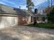 A side view shows a brick home with a two-car garage and an enclosed sunroom addition at 229 Smithstone Path, Fayetteville, GA 30214