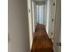 Hallway with hardwood floors connects various rooms, painted with light gray color at 229 Smithstone Path, Fayetteville, GA 30214