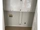 Practical laundry room with white cabinets and a neutral tile floor at 229 Smithstone Path, Fayetteville, GA 30214