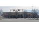 View of Stonecrest retail area with trees and expansive parking at 5984 Spring Way, Stonecrest, GA 30038